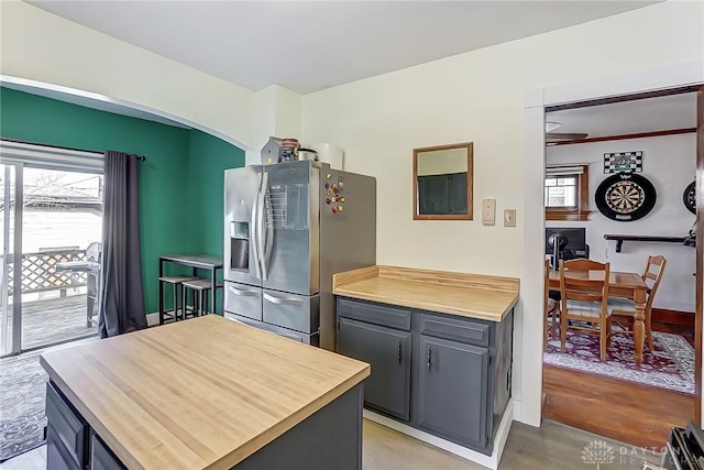 kitchen featuring stainless steel fridge and gray cabinetry