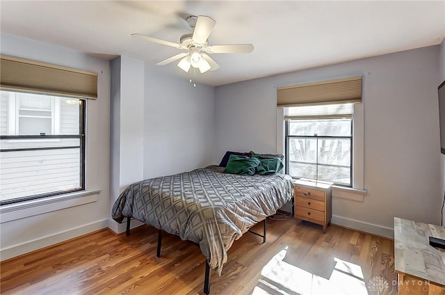 bedroom with ceiling fan and hardwood / wood-style floors