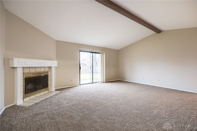 unfurnished living room featuring lofted ceiling with beams, a tile fireplace, and light carpet