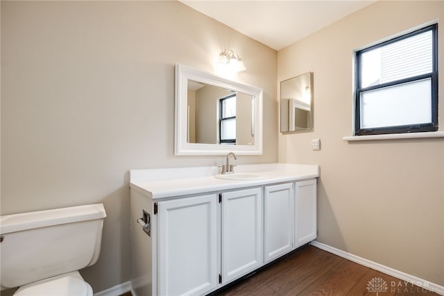 bathroom featuring hardwood / wood-style flooring, vanity, and toilet