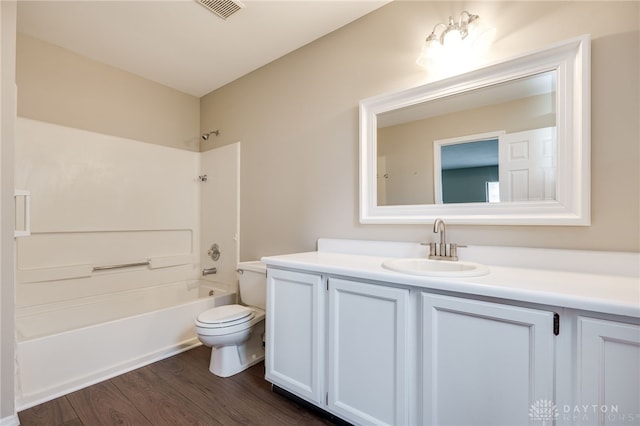 full bathroom with vanity, bathtub / shower combination, hardwood / wood-style floors, and toilet