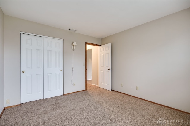 unfurnished bedroom with carpet and a closet