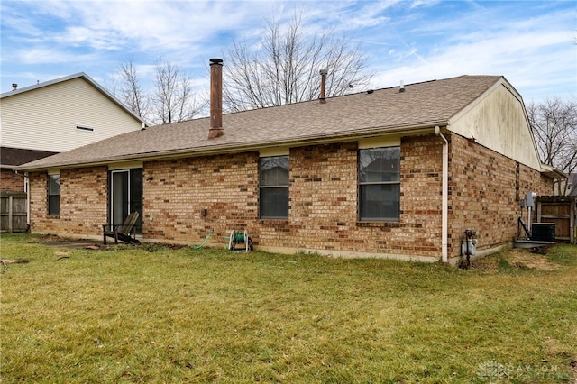 rear view of house featuring a lawn