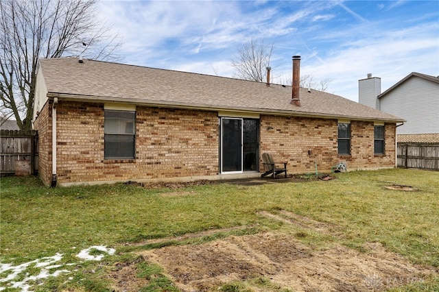 rear view of house with a yard