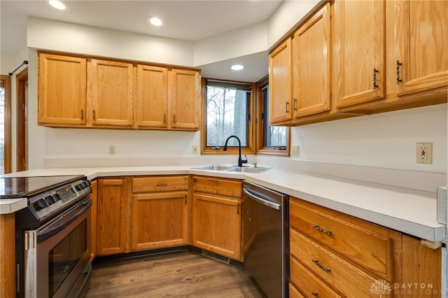 kitchen featuring appliances with stainless steel finishes, sink, and hardwood / wood-style floors