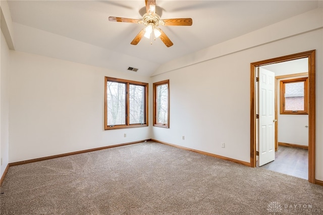 unfurnished room featuring vaulted ceiling, ceiling fan, and carpet