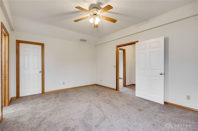 unfurnished bedroom with lofted ceiling, ceiling fan, and carpet flooring