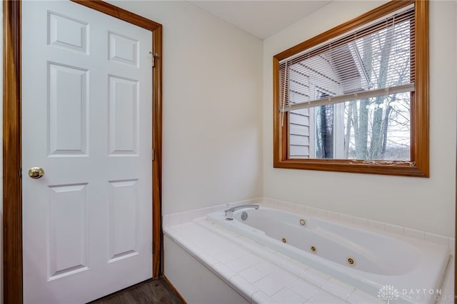 bathroom featuring a relaxing tiled tub