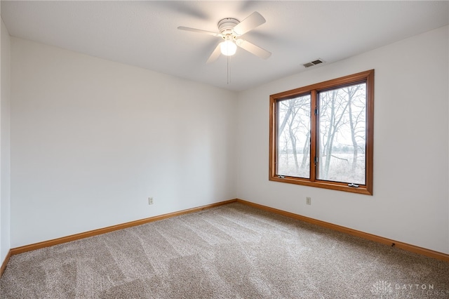 empty room with ceiling fan and carpet floors