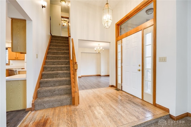 foyer entrance featuring hardwood / wood-style floors and a chandelier