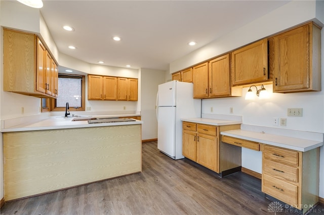 kitchen featuring dark hardwood / wood-style floors, sink, and white fridge