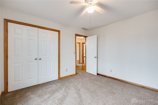 unfurnished bedroom with carpet floors, a closet, and ceiling fan