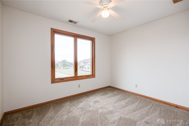 empty room featuring carpet and ceiling fan