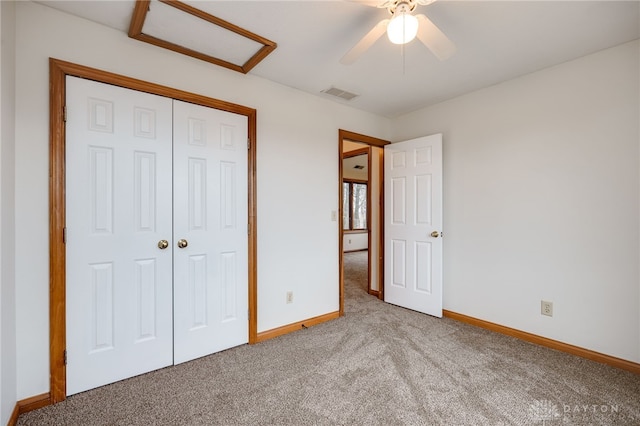 unfurnished bedroom featuring carpet, ceiling fan, and a closet