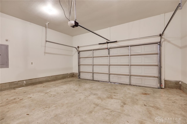 garage with a garage door opener and electric panel