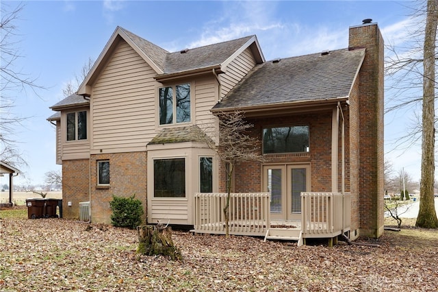 rear view of house with a deck and central air condition unit