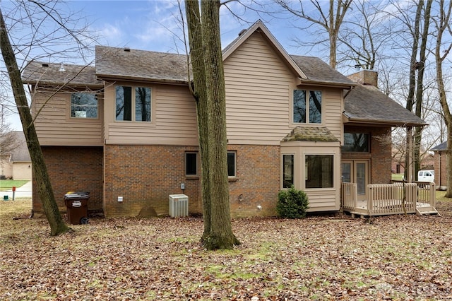 rear view of house with central AC unit and a deck