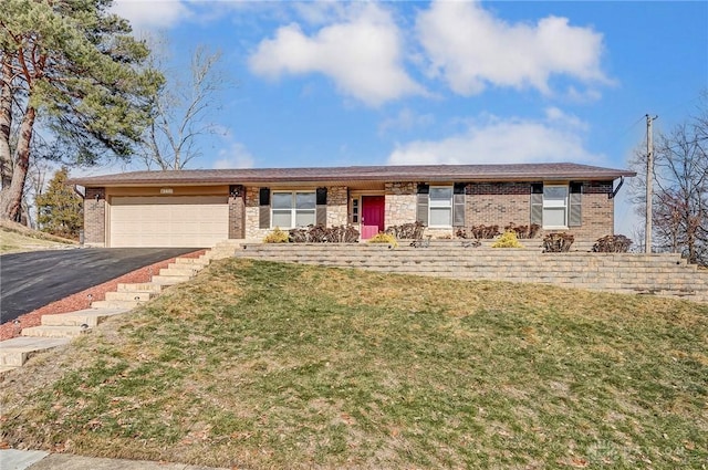 ranch-style home featuring a garage and a front lawn