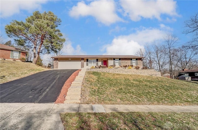 ranch-style home with a garage, aphalt driveway, a front lawn, and brick siding