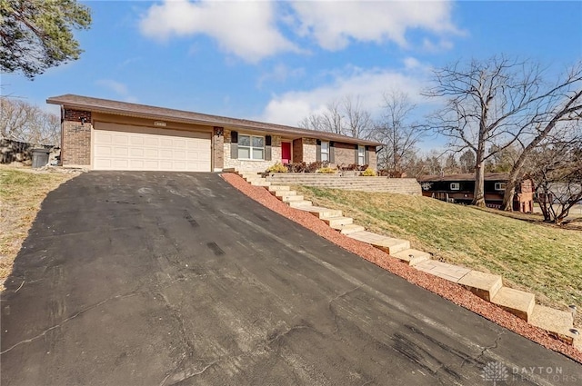 single story home featuring a garage and a front lawn