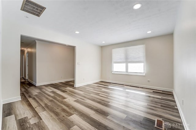 unfurnished room with wood-type flooring