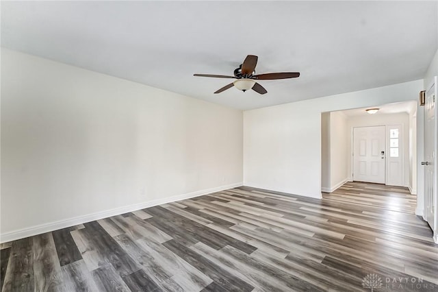 spare room featuring ceiling fan and dark hardwood / wood-style flooring