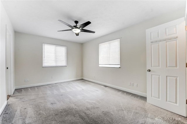 spare room with light carpet and ceiling fan