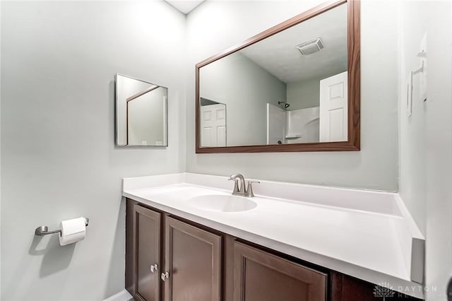 bathroom with vanity and walk in shower