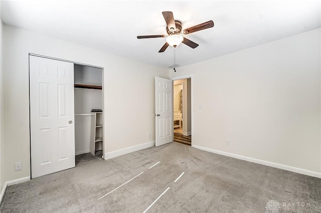 unfurnished bedroom with carpet flooring, ceiling fan, and a closet