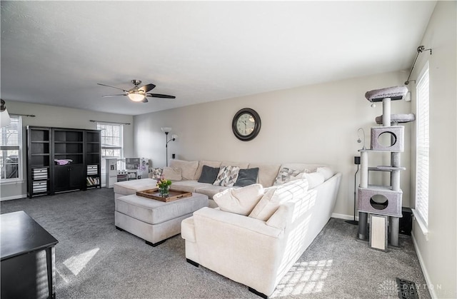 carpeted living room featuring ceiling fan