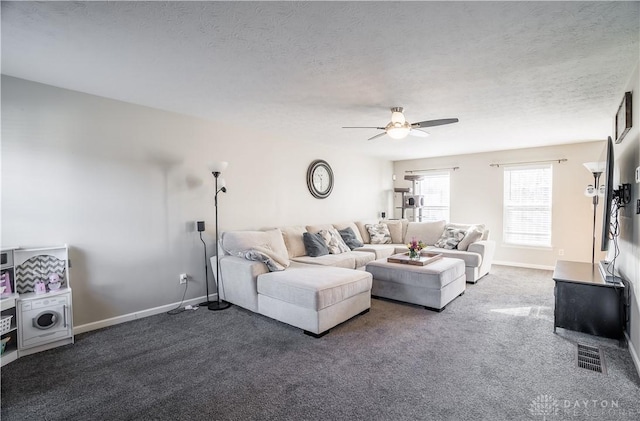 carpeted living room featuring ceiling fan and a textured ceiling