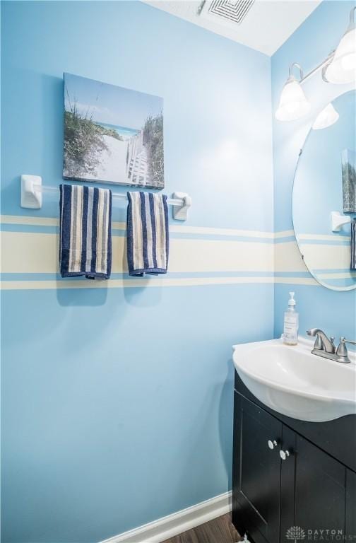 bathroom with vanity and hardwood / wood-style floors