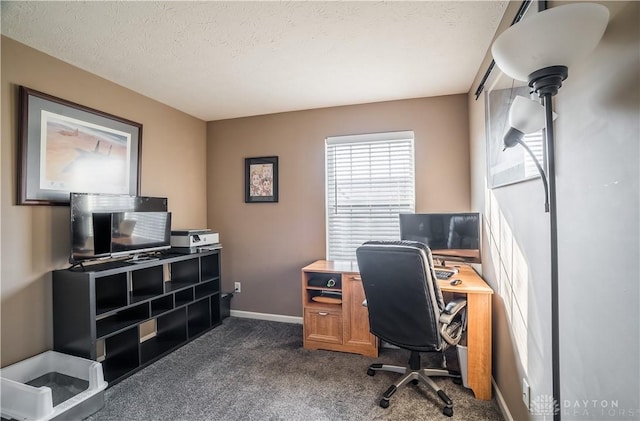 carpeted office space featuring a textured ceiling