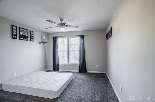 bedroom with ceiling fan and dark colored carpet