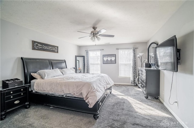 bedroom featuring ceiling fan, carpet, and a textured ceiling