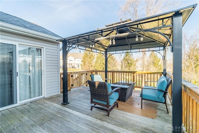 deck with a gazebo and an outdoor living space with a fire pit