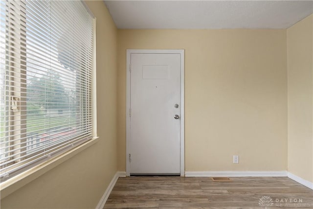 empty room with light hardwood / wood-style flooring