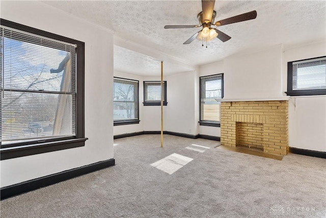 unfurnished living room with light carpet, ceiling fan, and a textured ceiling