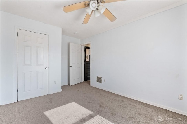 unfurnished bedroom with light carpet and ceiling fan