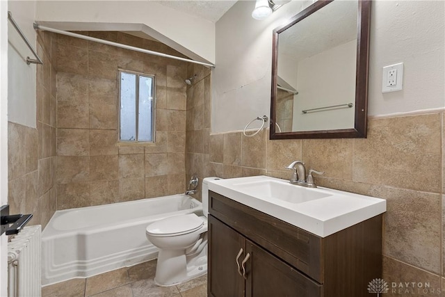602 Rockford Ave, Dayton, OH 45405 - bathroom with radiator, shower / washtub combination, toilet, vanity, and tile walls