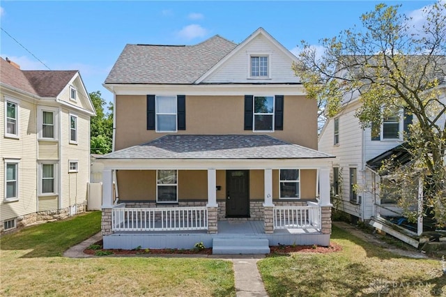 view of front of home with a porch and a front yard