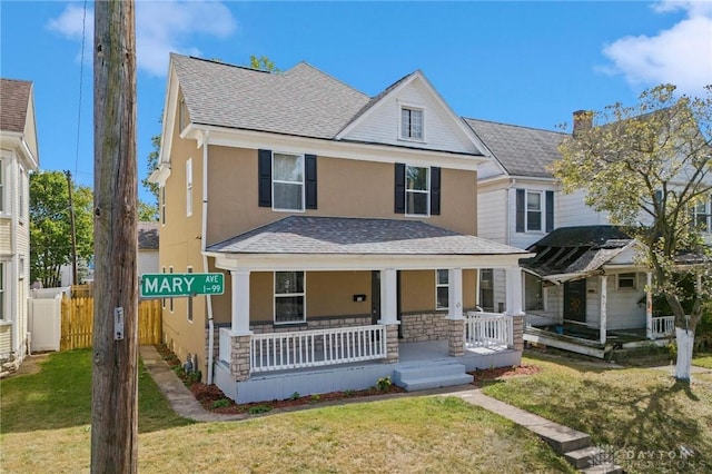 view of front of home with a front yard and covered porch