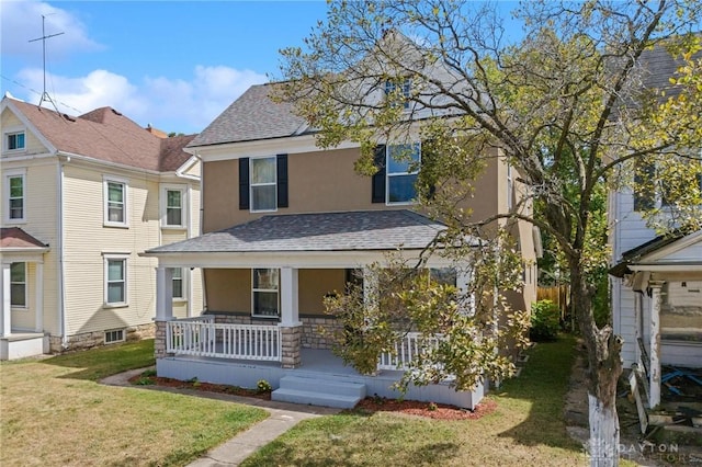 view of front of home featuring covered porch and a front lawn