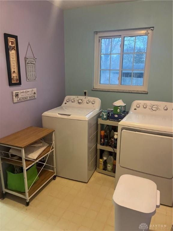 laundry room with laundry area, independent washer and dryer, and light floors