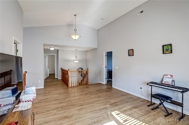 interior space featuring high vaulted ceiling and light wood-type flooring