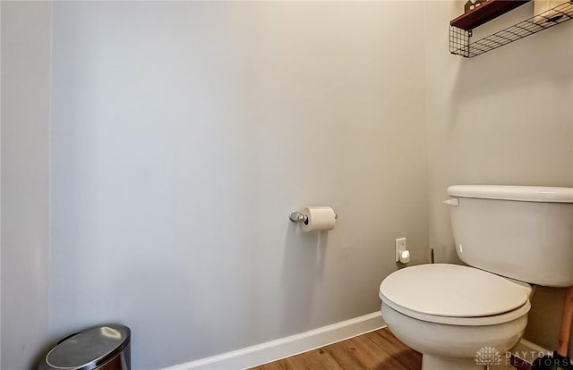 bathroom featuring wood-type flooring and toilet