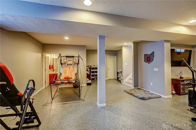 workout room featuring a textured ceiling