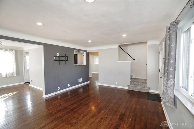 unfurnished living room featuring dark hardwood / wood-style floors