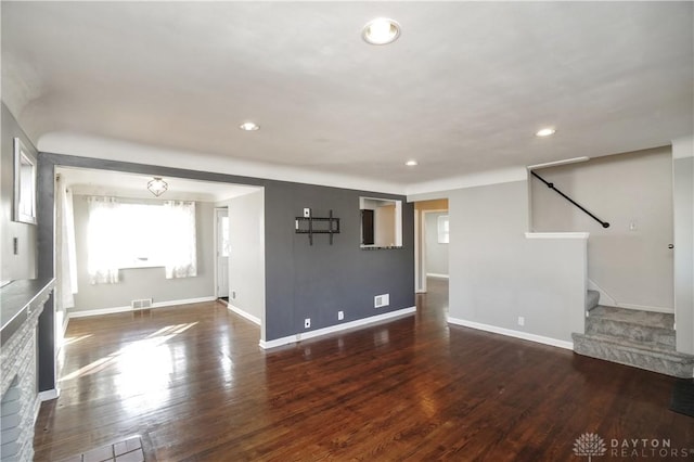 unfurnished living room featuring dark hardwood / wood-style floors