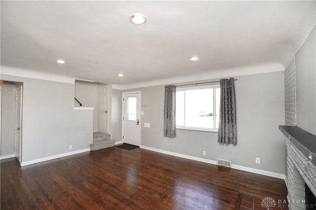 unfurnished living room featuring dark hardwood / wood-style floors